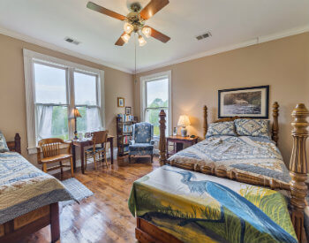 The Otter Creek room has fawn brown walls, one double bed, one twin bed and comfortable chairs and desk.