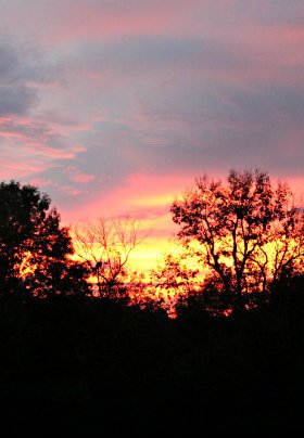 The view from a rocker on the porch provides a magnificent orange sunset